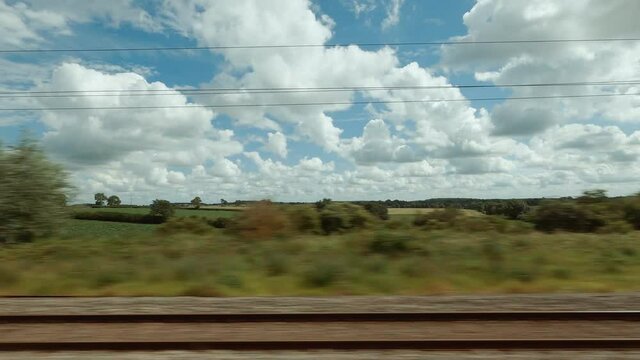 Wheat fields in the Yorkshire Dales seen from a moving train during early afternoon, in Yorkshire, England, UK