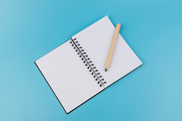 Blank paper and pencil on a blue background