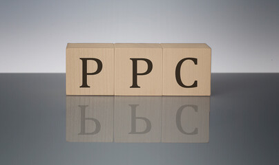 PPC concept, wooden word block on the grey background