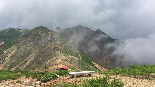 Mt Nasu-dake (Asahi-dake) and a red hut, Mine-no-Chaya with some clouds in Nasu, Tochigi, Japan. July 20, 2021.