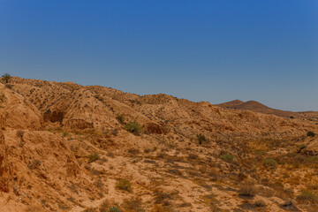 Hills and rocks of the Atlas mountains with some greens