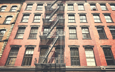 Obraz premium Old building with iron fire escape, color toning applied, New York City, USA.