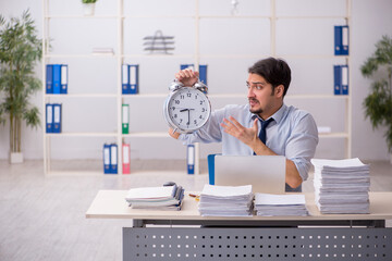 Young businessman employee unhappy with excessive work in the of