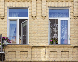 Two open windows in a town house.