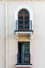 Fototapeta na wymiar Window and balcony door on the facade of a house.