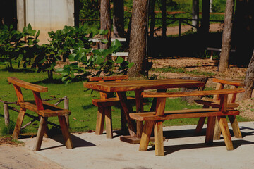 Tables and chairs made of wood in the garden.