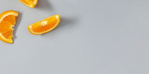 Orange slices on gray background. Fruit background. Flat lay, top view, copy space