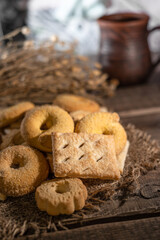 Homemade cookies with a cup of milk on a rural wooden background