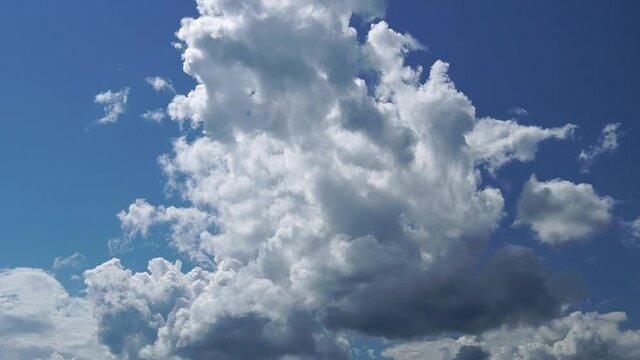 A large gray cloud in the blue sky flies into the air. No buildings. Full HD Time Lapse 1080p