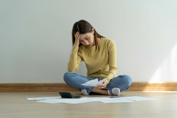 Female headache and stress with monthly bills and credit card debt.
