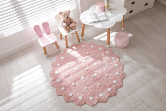 Round Pink Rug On Floor In Children's Room, Above View