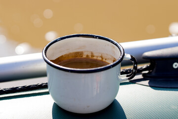 metal mug on a background of the river