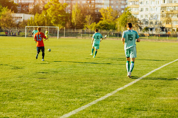 footballer plays a dynamic game in a professional stadium, a group of young footballers play on an open court