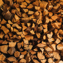firewood background, wood texture. Woodshed with firewood. Brown background.