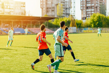 football players in action at the stadium, Football game for adults, Players of two teams competing for the ball