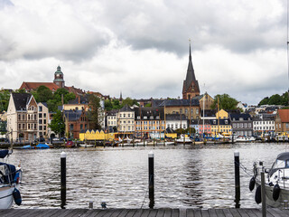 Sail boats in the port of Flensburg, St. Jorgen's Church in the background. Schleswig-Holstein in Germany