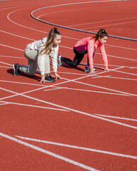 Toe the starting line. Athletic children in starting position. Running. Athletics. At the start