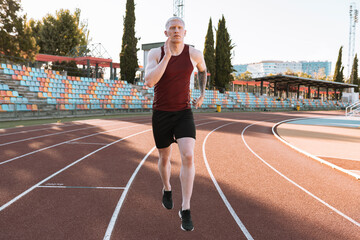 athlete man running on running track