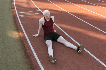 athlete man sitting on running track