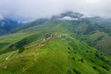 Naklejka premium Aerial view of Tmenikau village on cloudy summer day. North Ossetia–Alania, Caucasus, Russia.
