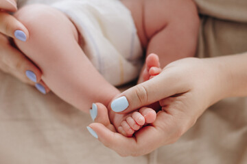 Mother holding baby feet