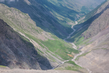 View of Genaldon river valley from Mount Kazbek slope on sunny summer day. North Ossetia&ndash;Alania, Caucasus, Russia.