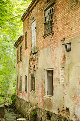 Abandoned red brick building by the river.