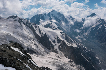 Obraz premium View of Mayly and Kolka glaciers on sunny summer day. North Ossetia–Alania, Caucasus, Russia.