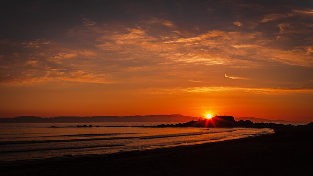 Sunset on the beach at the greek  village Arkoudi