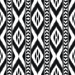 Ikat seamless pattern for home decor ideas, textile, wallpaper, card or wrapping paper. Ethnic, indian, boho fashion style. Tribal vector background. Black and white graphic design. - 447872946