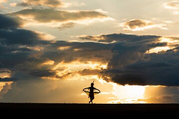 The shadow of the traditional dancers of southern Thailand with beautiful poses. With the sunlight in the evening, it's beautiful.