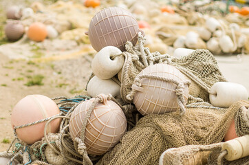 Fishing net with spherical buoys lay on the coast.