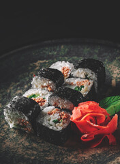 sushi roll in plate on black wooden table background
