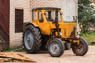 Fototapeta na wymiar Old Soviet Russian tractor with trailer 