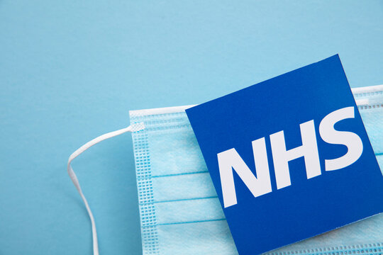 LONDON, UK - July 2021: NHS National Health Service Logo With Covid Mask