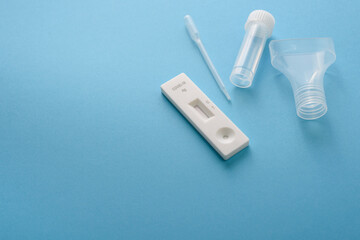 Covid19 antigen test kit with cassette, pipette and plastic bottle for saliva - obrazy, fototapety, plakaty