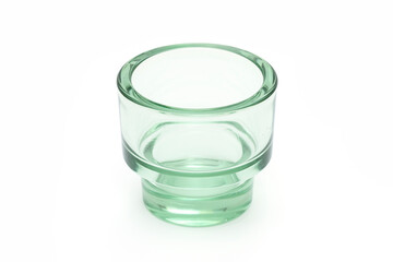 Green glass cup on the white background.
