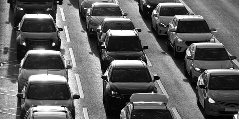 Fototapeta premium cars are in a traffic jam in three rows in the evening sunny city