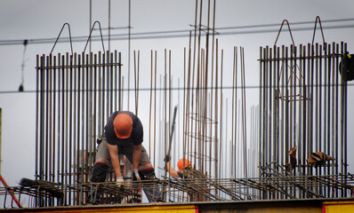 Workers and builders are building a housing complex made of concrete