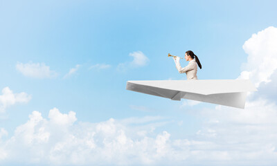 Attractive woman playing trumpet brass