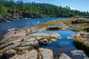 Wildlife landscape of the Valaam nature reserve. Holy Island. Stone shore against which the waters of Lake Ladoga beat.