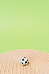 Soccer balls on a wood on a green background. football and sport concept.