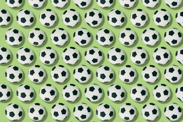 Pattern of soccer balls on a green background. football and sport concept