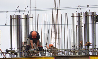 Workers and builders are building a housing complex made of concrete