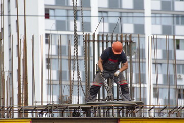 Workers and builders are building a housing complex made of concrete
