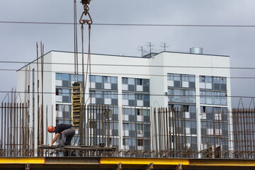 Workers and builders are building a housing complex made of concrete