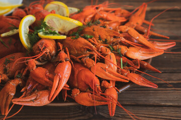 boiled crayfish served on a platter with herbs and lemon