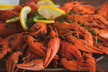 boiled crayfish served on a platter with herbs and lemon