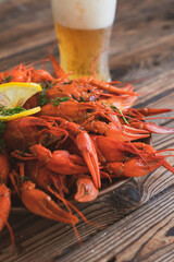 boiled crayfish served on a platter with herbs and lemon