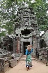 Happy woman traveller walking in Angkor Wat Cambodia.